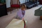 Rebecca begins to unfold her quilt.  She was excited to be first, I presented them individually to capture their reactions