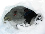 Alan taking a break from digging inside the snow cave.